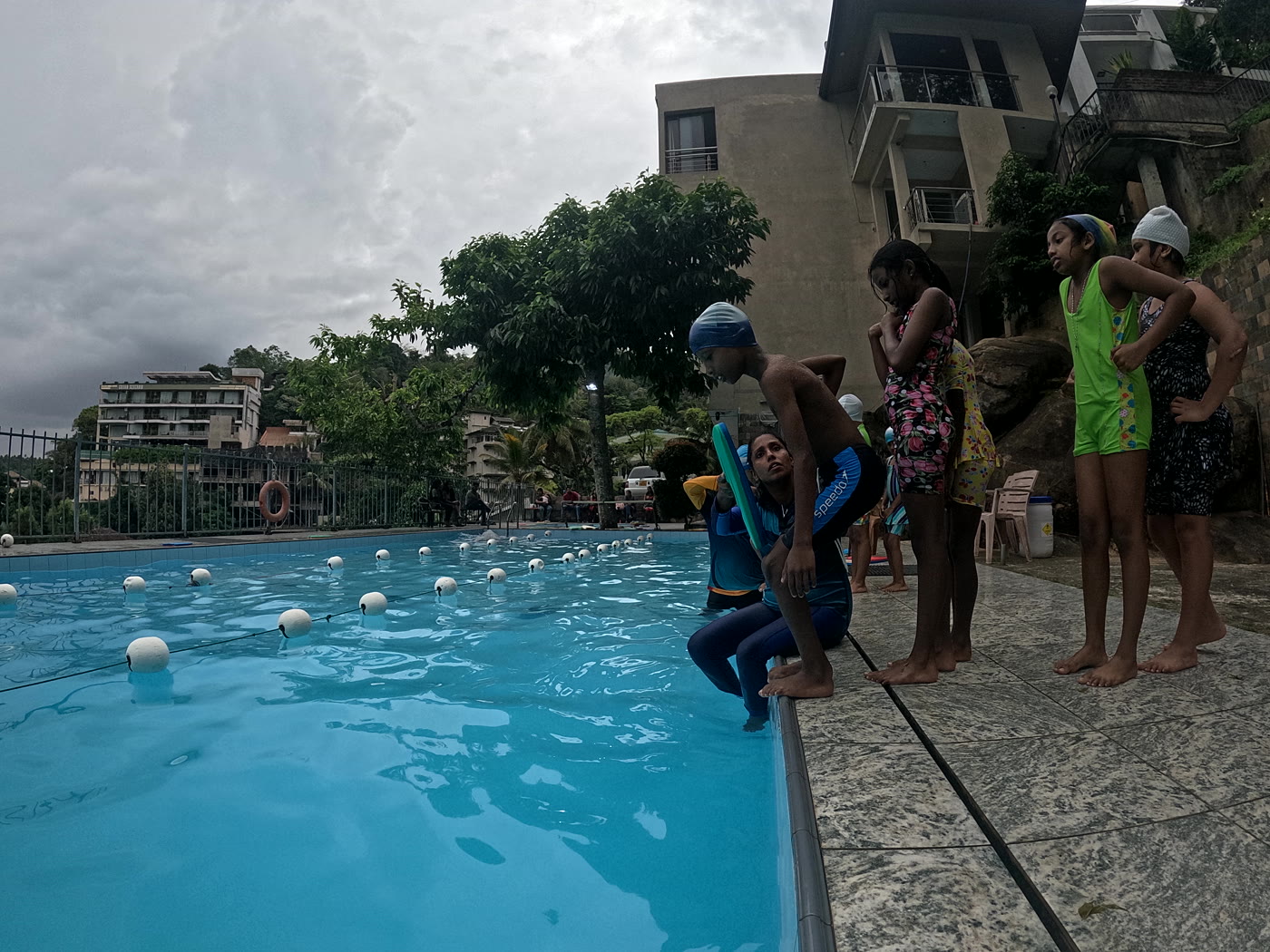 Stingrays coach teaching kids at a pool